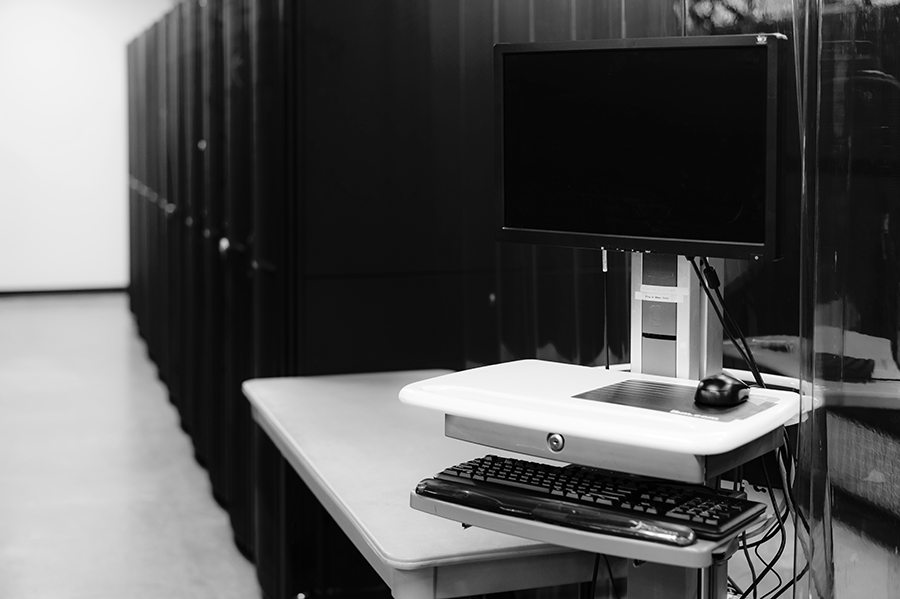 A computer with servers in the background