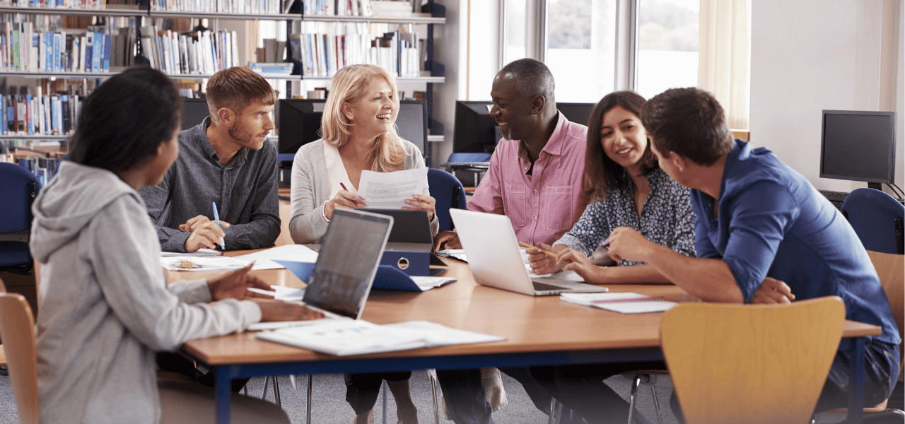 A group of people having a discussion in the library.