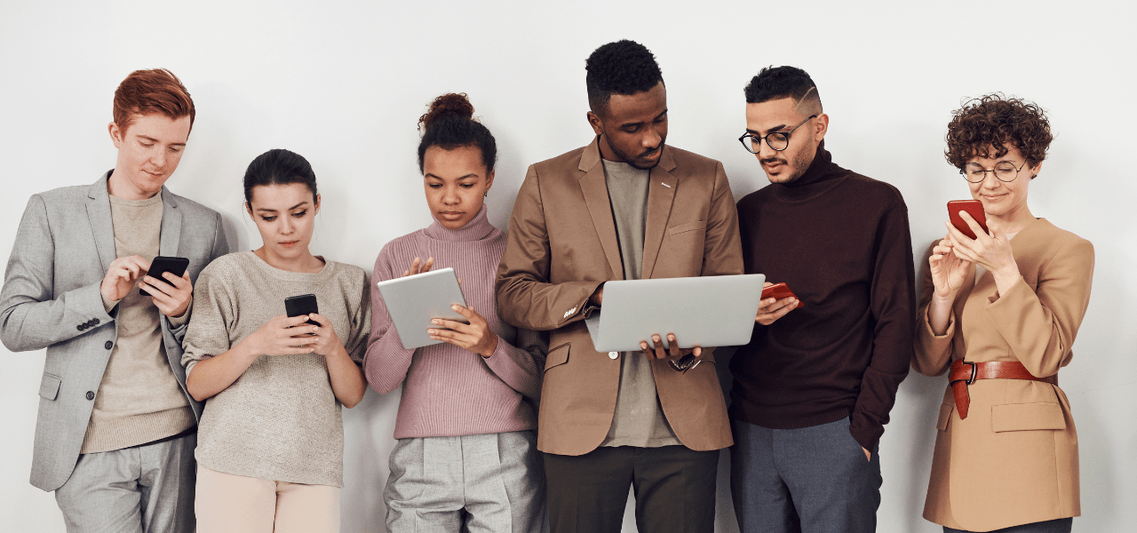 People using a variety of devices: mobile phone, tablet and laptop computers.