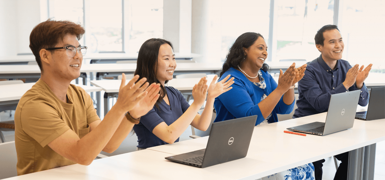 A group of people clapping their hands.