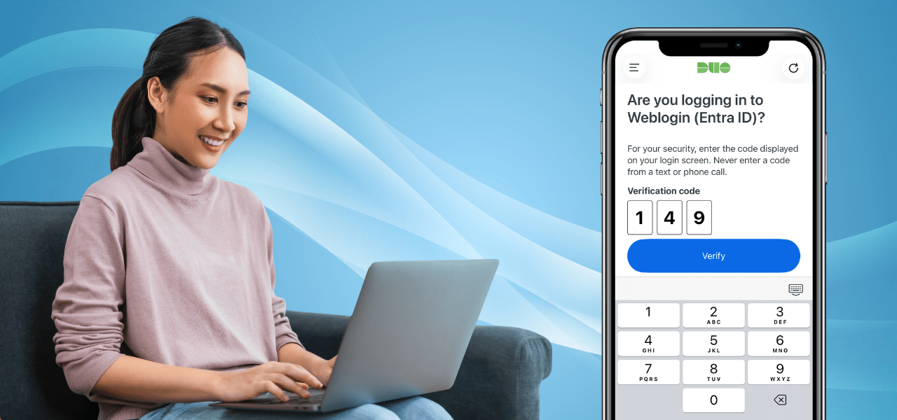 Person using a laptop beside a smartphone displaying a Duo Mobile verification screen with a three-digit code prompt for secure login authentication.